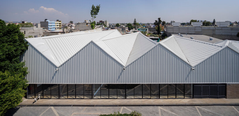 metallic roof shapes triangular folds atop a|911's cultural infrastructure in mexico city