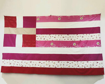 pink greek flag made of bed sheets by artist georgia lale addresses domestic violence