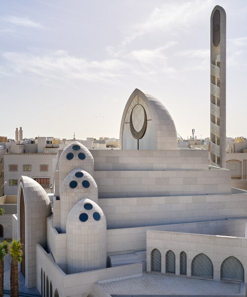 rhythmically stacked, rotating volumes and half domes compose kuwaiti mosque