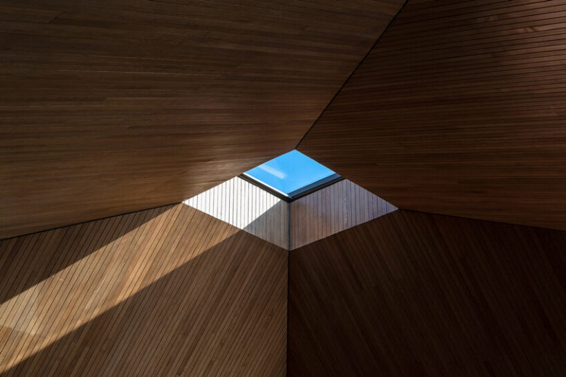 wooden pyramid skylight illuminates suoi hai villa's interior in vietnam