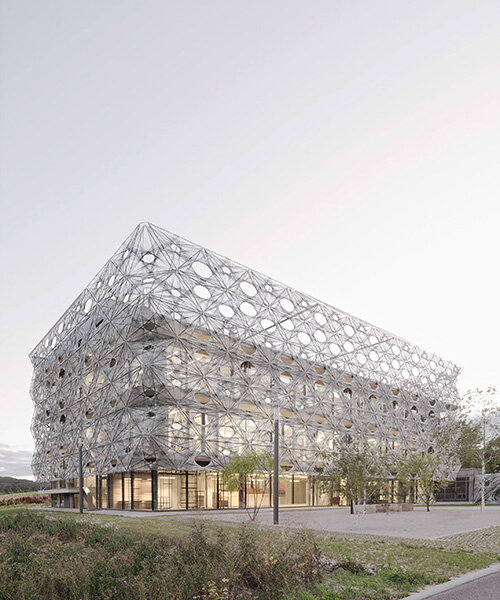 veiled in robotically woven facade, texoversum university building opens in germany