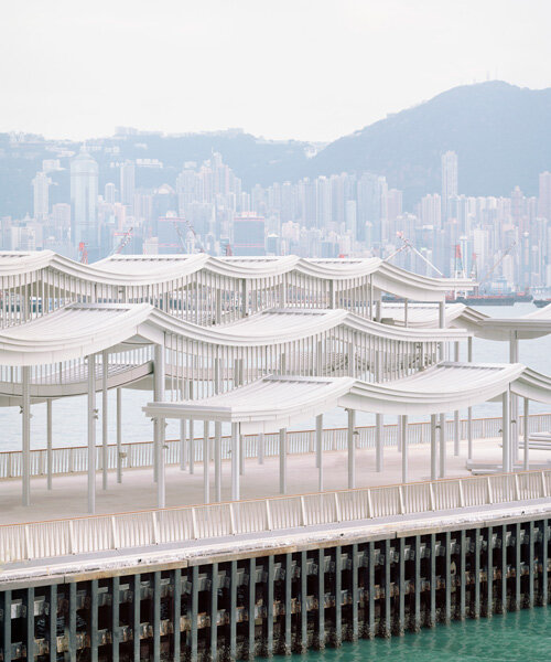 undulating canopy by new office works shelters waterfront promenade in hong kong