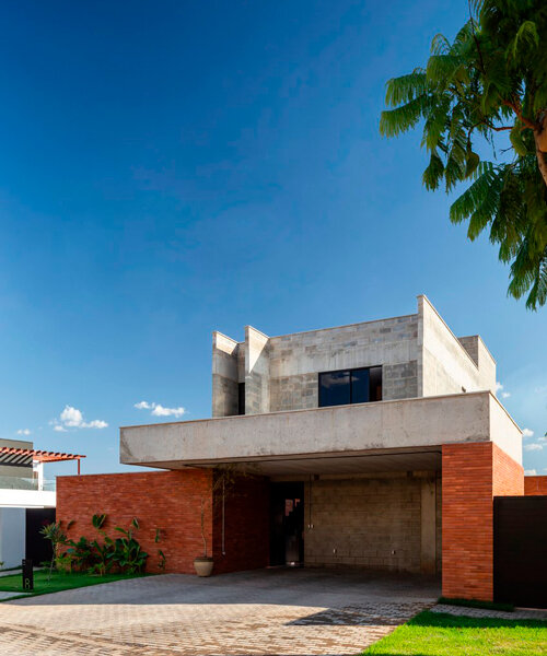 red brick and concrete stacked blocks shape vão house in brazil