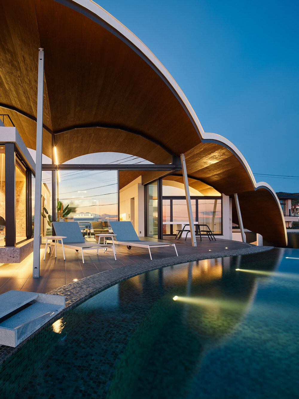 teamSTAR crowns villa A with a vaulted roof echoing japan's rolling ocean waves