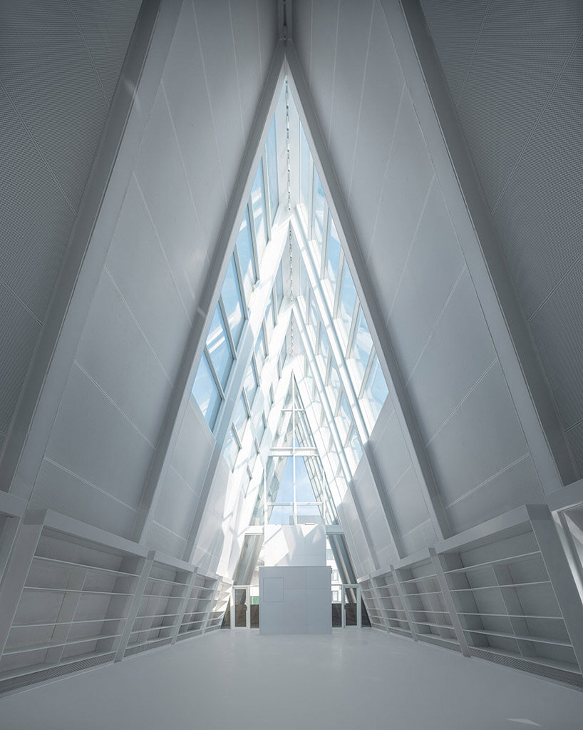 UAO design's liangzi island pier is punctuated by a glowing A-frame 'lighthouse'