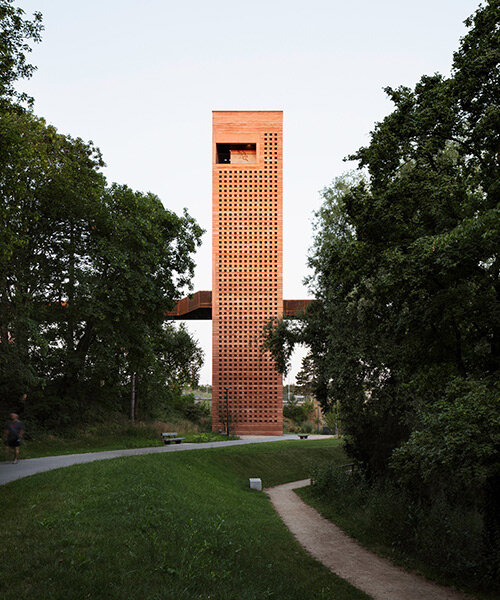 MONO architekten builds a tower of red-tinted rammed earth in germany
