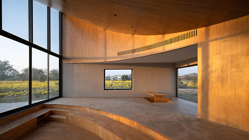 rural library by atelier xi is a cluster of angular blocks in a flower field