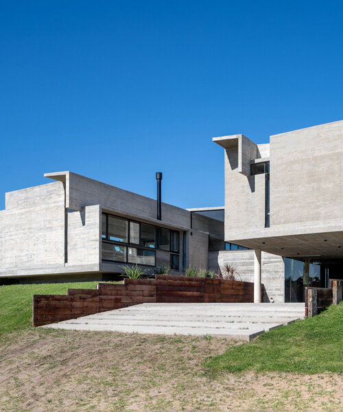 two elevated rectangular concrete prisms shape residence on the buenos aires coast