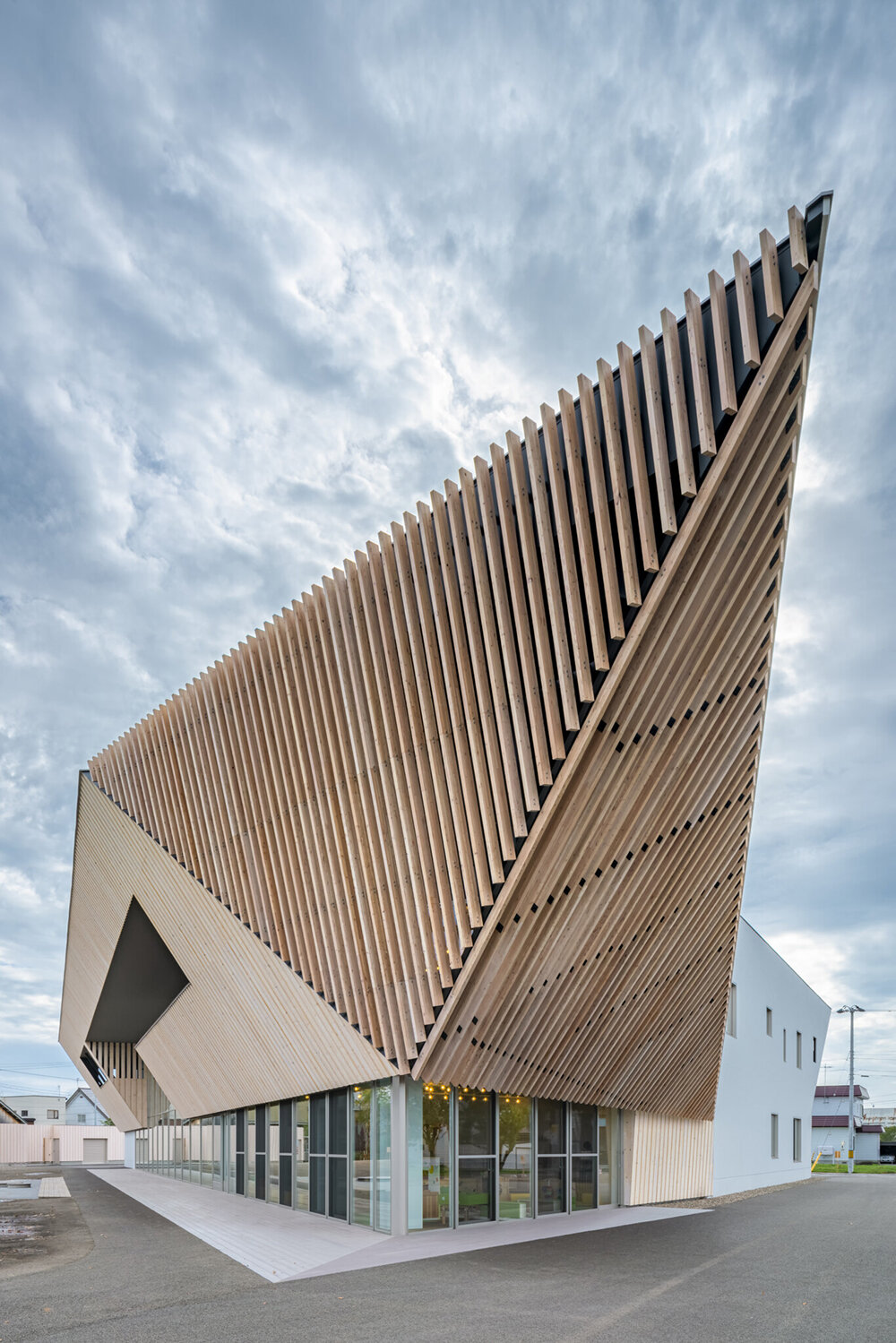 kengo kuma sculpts tessellated wooden eaves for higashikawa community plaza in japan