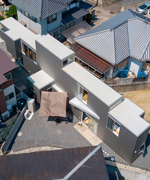 elongated house KJ lies on narrow flagpole lot between residences in japan