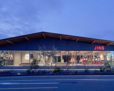 gentle gable roof overcasts wooden frame of eyewear store in japan