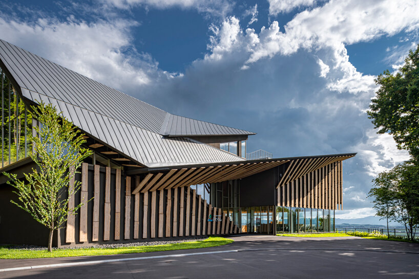 kengo kuma cloaks hot spring resort in hokkaido with locally sourced larch wood