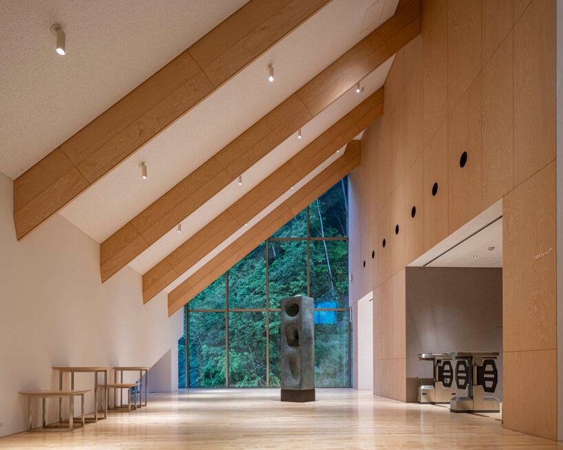 kengo kuma cloaks hot spring resort in hokkaido with locally sourced larch wood