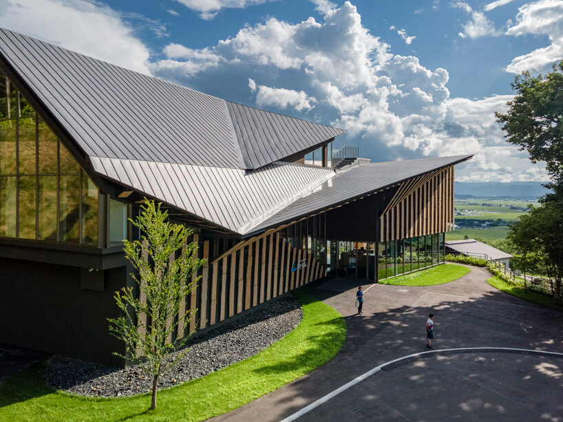 kengo kuma cloaks hot spring resort in hokkaido with locally sourced larch wood