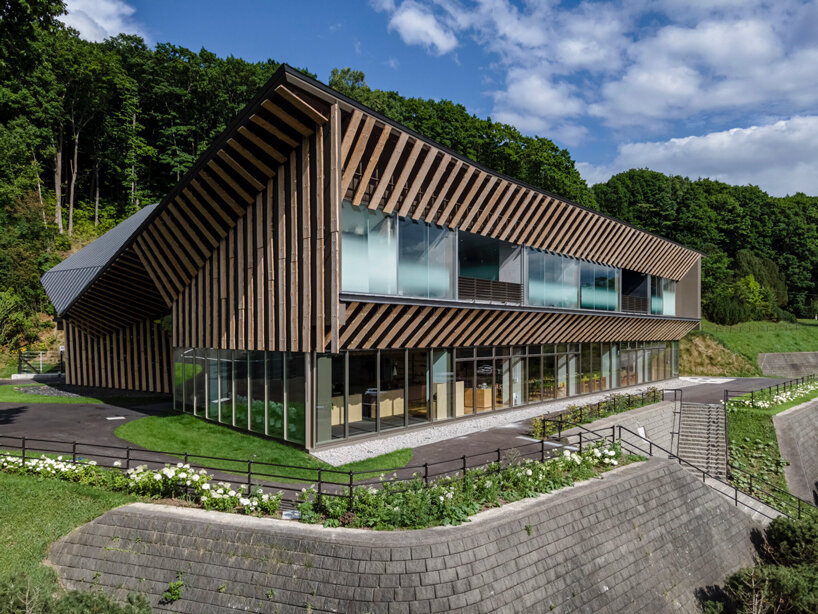 kengo kuma cloaks hot spring resort in hokkaido with locally sourced larch wood