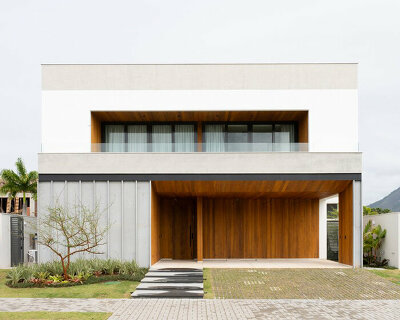 wood-clad pockets carve monolithic concrete residence in rio de janeiro