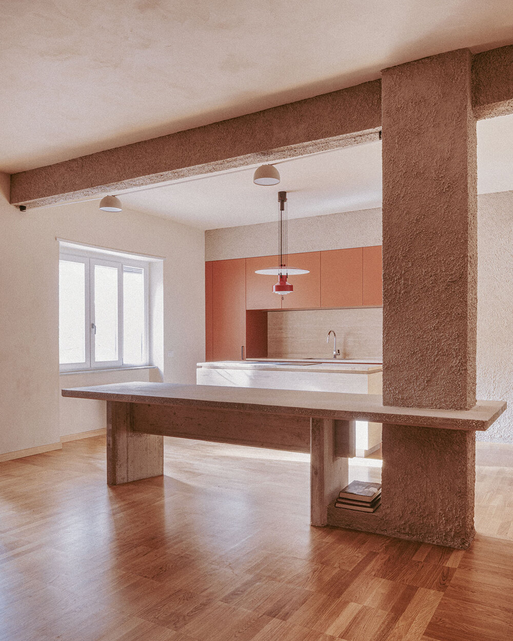 exposed column takes center stage inside studio traccia's renovated 1970s flat in rome