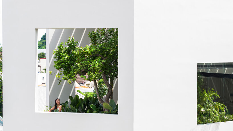 cut-out patios bring nature inside pham huu son's skygarden house in vietnam