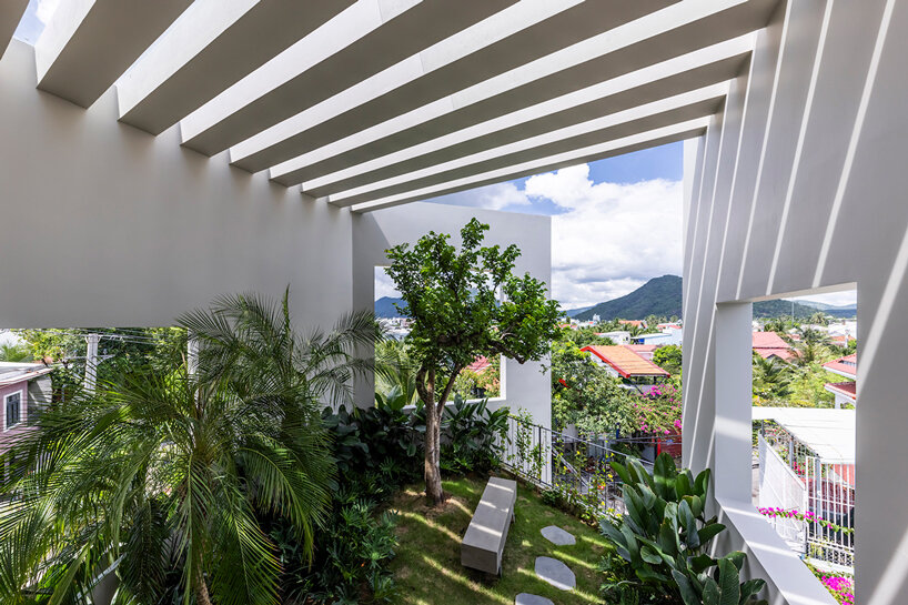cut-out patios bring nature inside pham huu son's skygarden house in vietnam