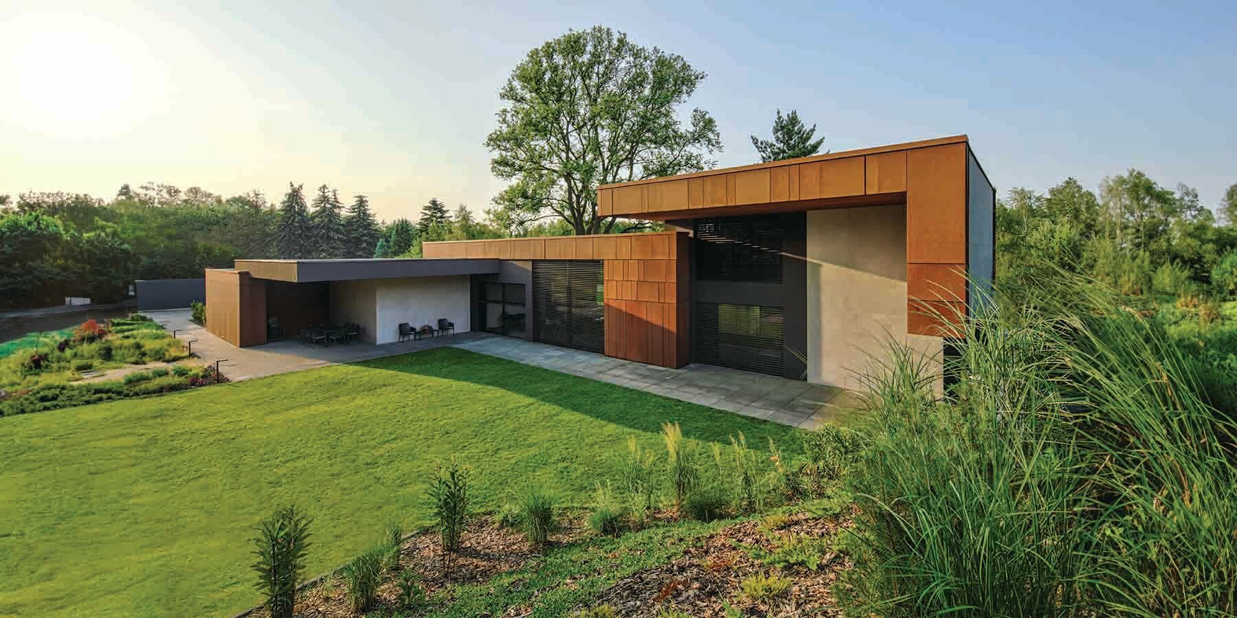 corten steel clads vero casa's intertwined volumes in poland