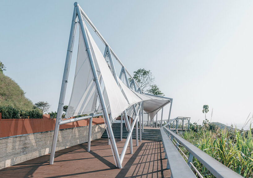 covered in sheer white mesh, this daydream trail station casts a poetic glow in coastal china