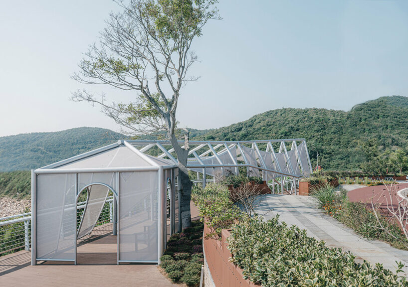 covered in sheer white mesh, this daydream trail station casts a poetic glow in coastal china