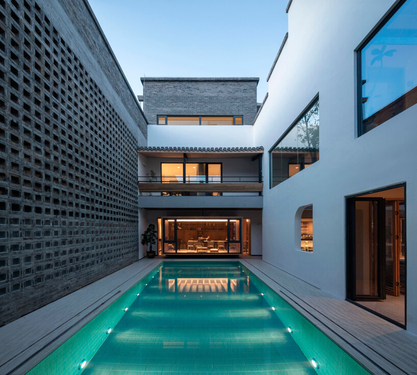 elongated gray brick cladding envelops hotel in chinese ancient village