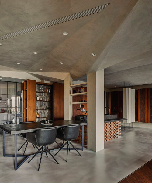 multifaceted concrete ceiling floats above residential space in taiwan