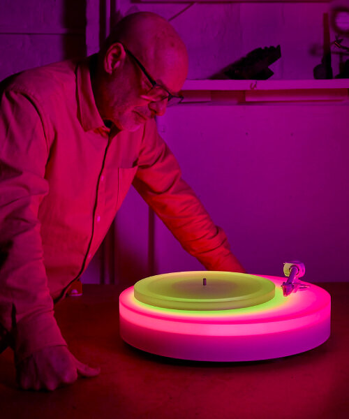 brian eno’s turntable II glows in different acrylic neon lights as the vinyl record plays