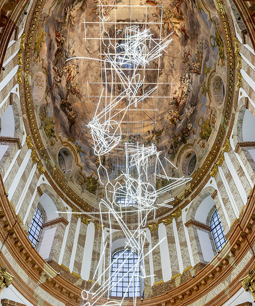 cerith wyn evans suspends neon squiggle installation within baroque church in vienna