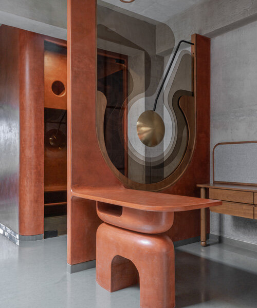 warm terracotta hues adorn design ni dukaan's sculptural office interior in india