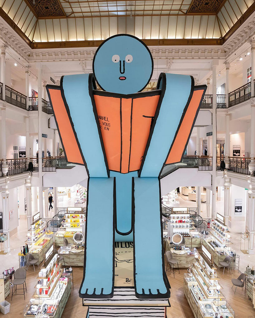 jean jullien's paper giants land at le bon marché for book-themed exhibition in paris