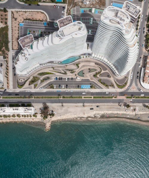 rippling ship-like volumes unite luxury commercial and residential spaces at limassol seafront