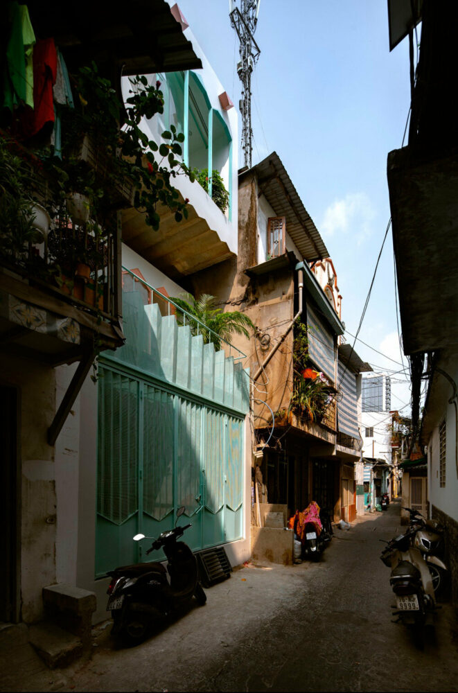 Một công xôn rời rạc nhô ra từ nhà của AD+ Studio trong một con hẻm hẹp ở Việt Nam