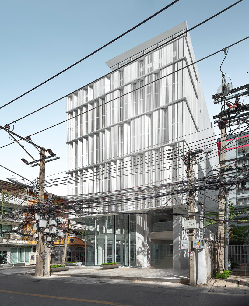 zigzag curtain wall enfolds silom residence's living units in bangkok