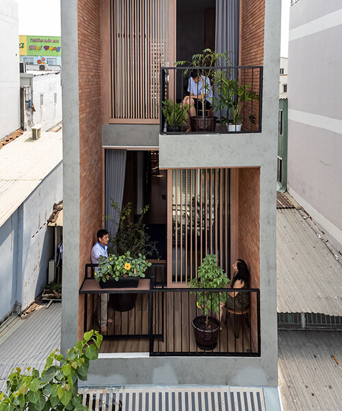 story architecture fronts this narrow house in vietnam with stacked terraces