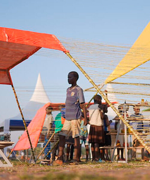 colorful angular tents shape puzzle-like zanya pavilion in northern uganda