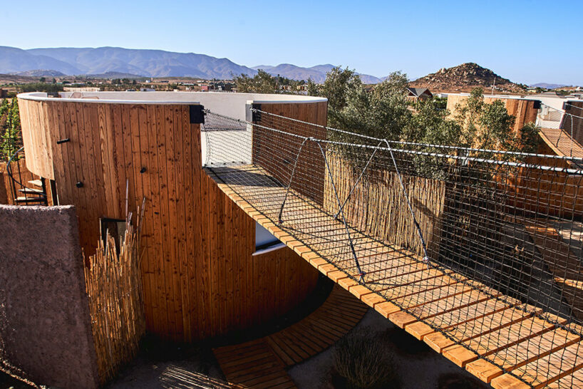 terraces and hanging bridges connect the zeuhary cabins in a mexican vineyard