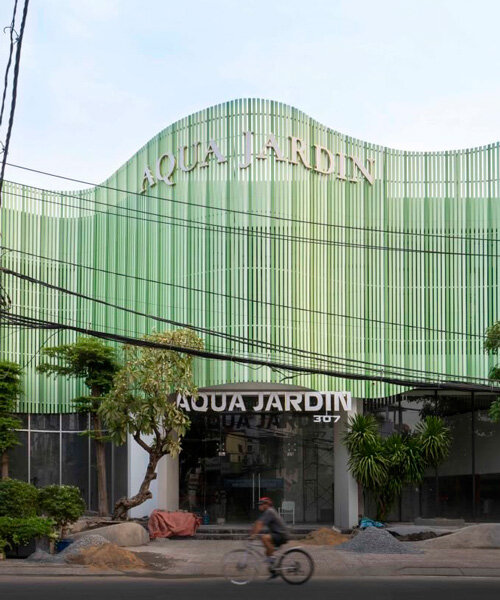 reused wooden panels compose undulating facade for aqua jardin wedding venue in vietnam