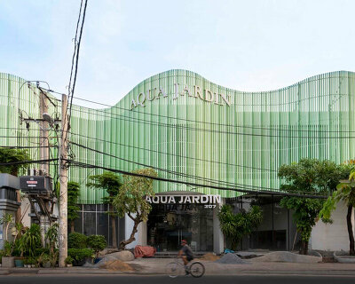 reused wooden panels compose undulating facade for aqua jardin wedding venue in vietnam