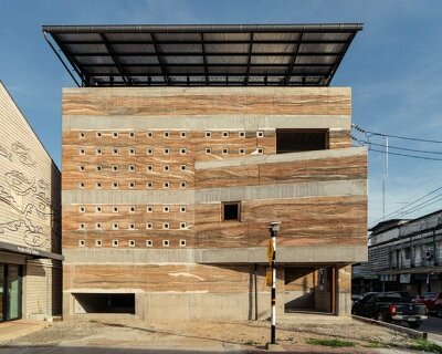 metal mesh skin adorns art center's concrete facade in bangkok