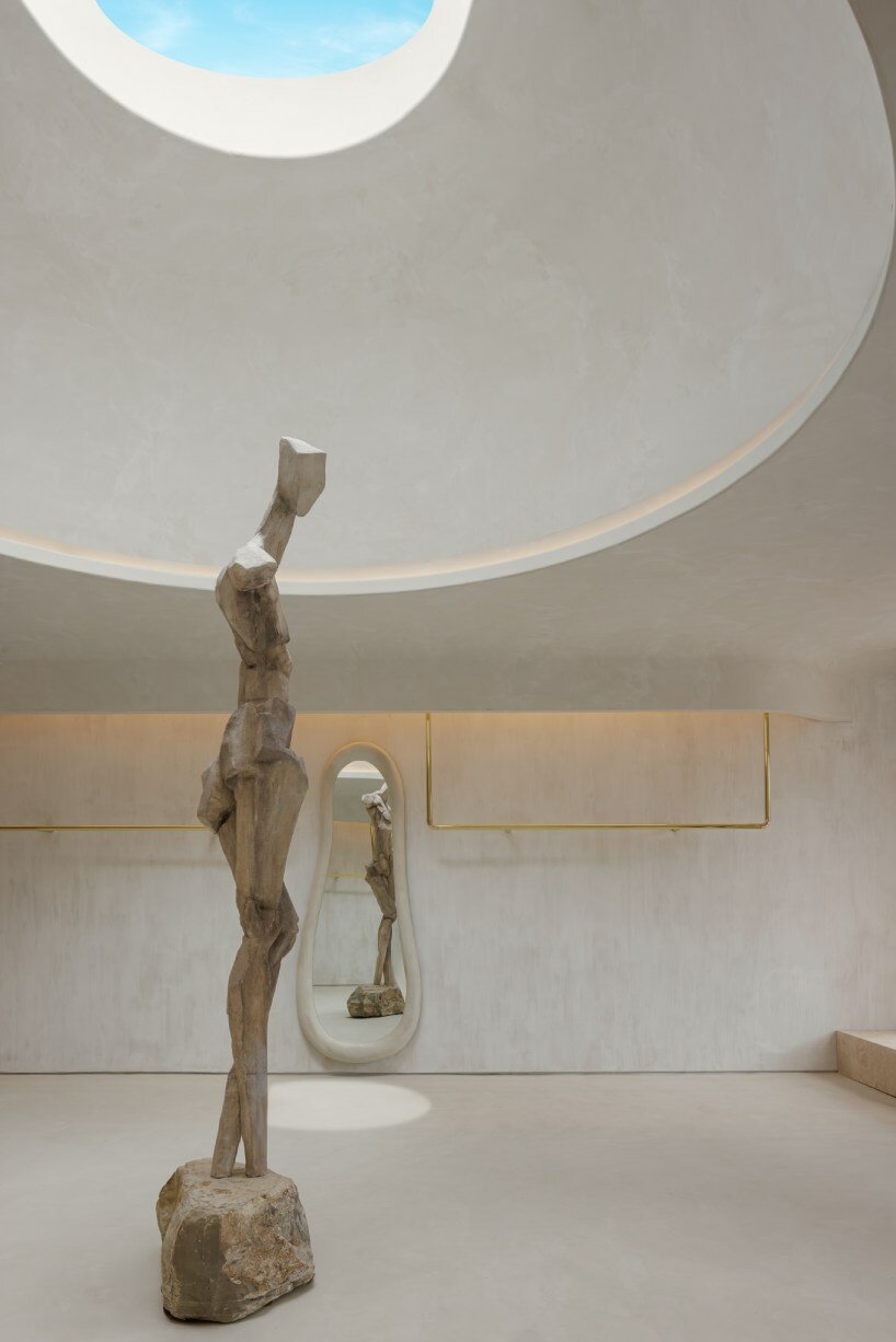 soaring sculpture and banyan tree pierce oculi of sugarhouse's miami fashion store