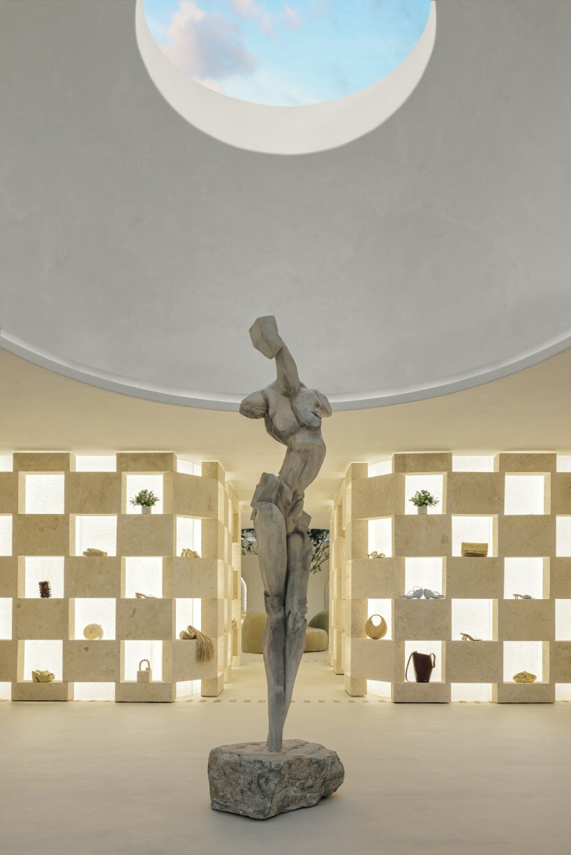 soaring sculpture and banyan tree pierce oculi of sugarhouse's miami fashion store