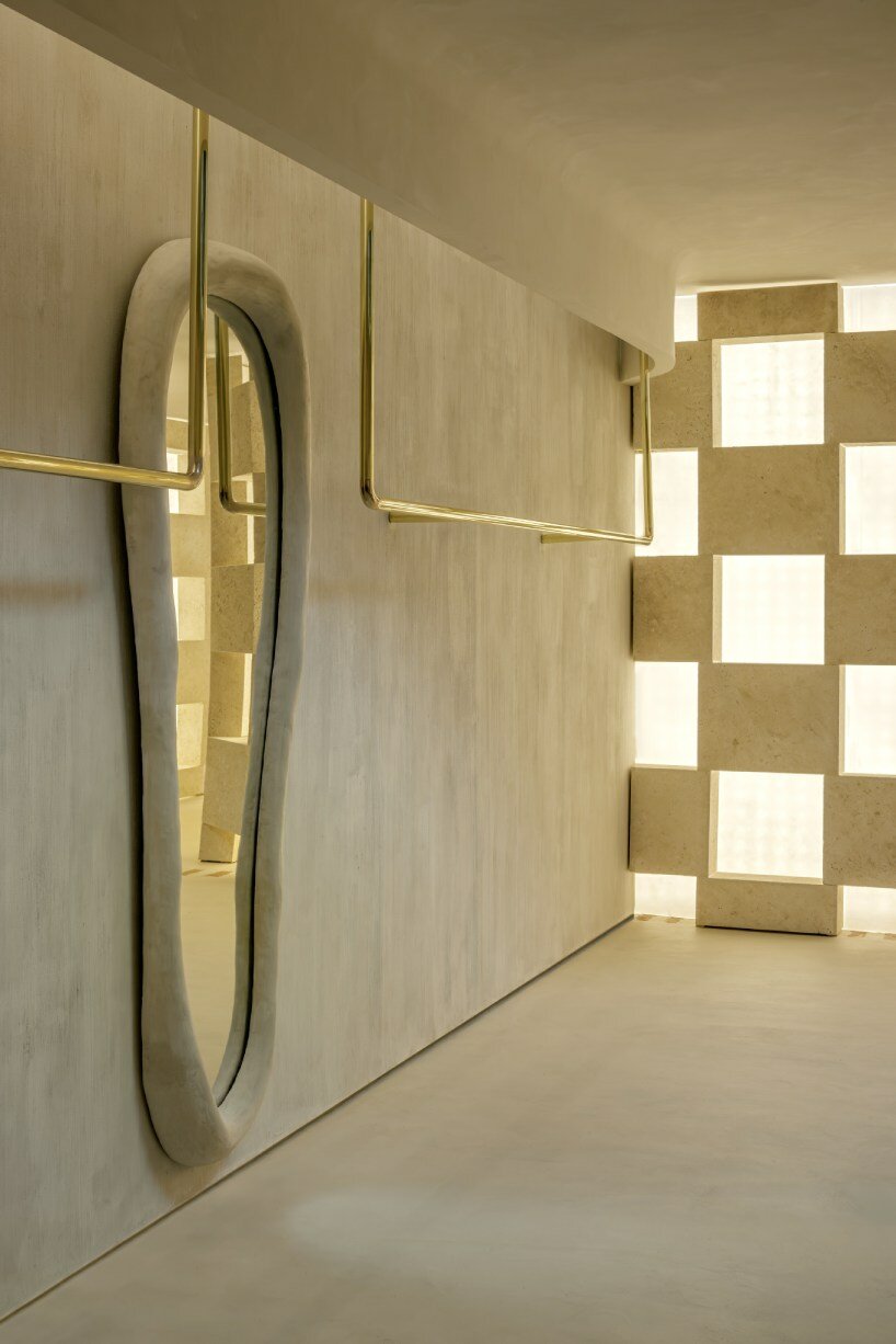 soaring sculpture and banyan tree pierce oculi of sugarhouse's miami fashion store