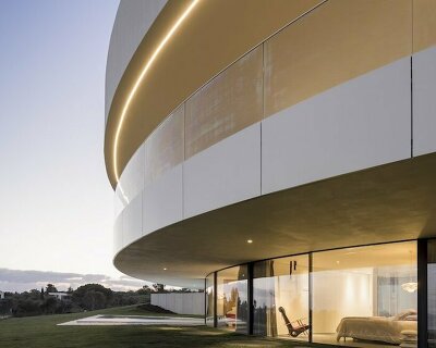 defying orthogonality with curved windows that merge architecture and landscape