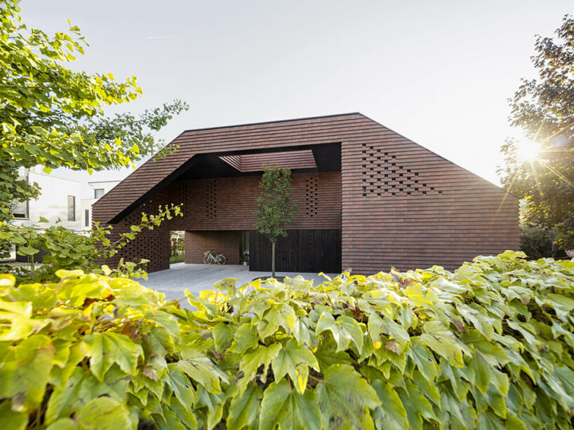 Brick canopy doubles as playground for OFIS Architects' frame house in Slovenia