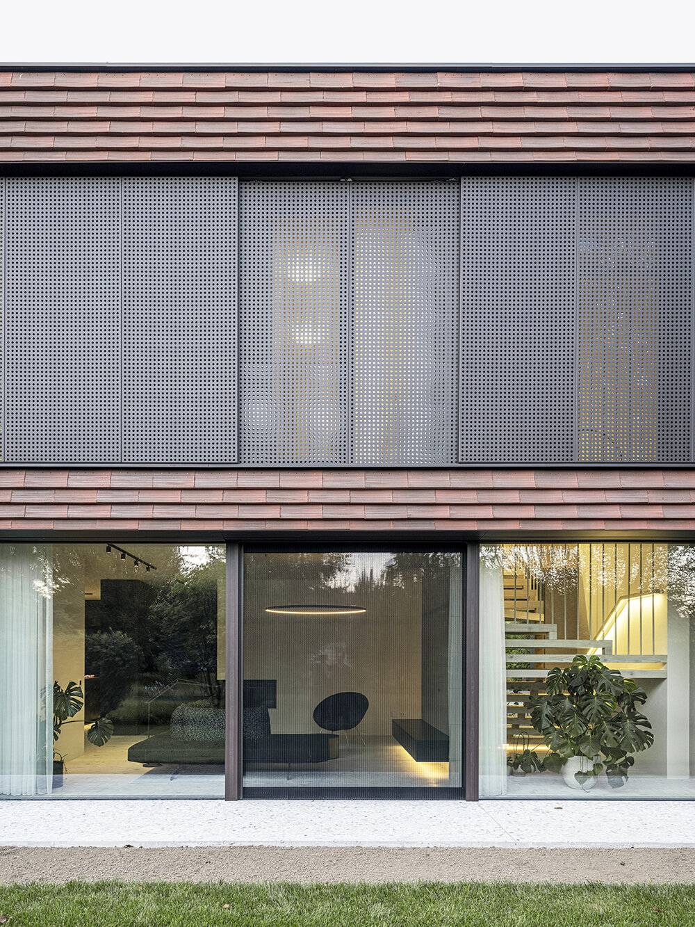 Brick canopy doubles as playground for OFIS Architects' frame house in Slovenia