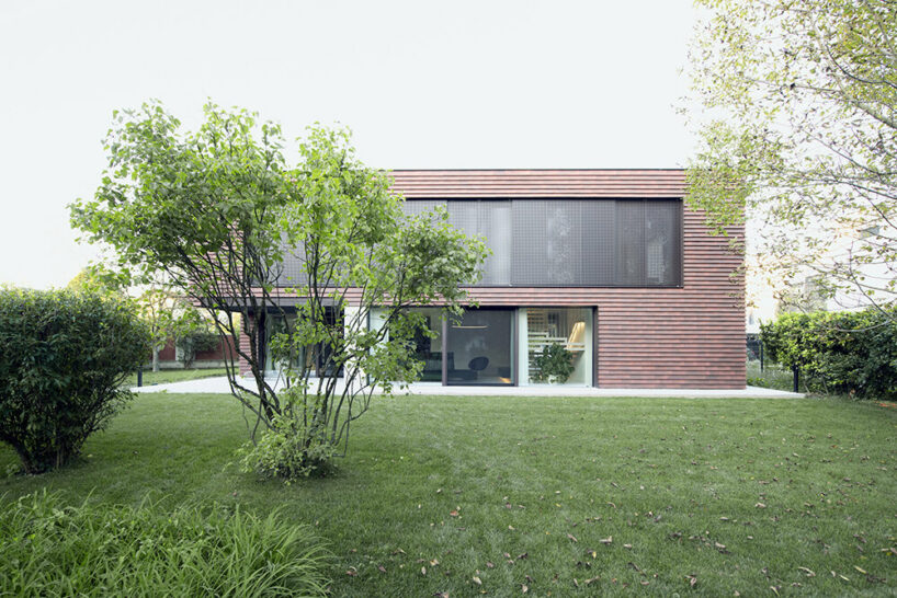 Brick canopy doubles as playground for OFIS Architects' frame house in Slovenia