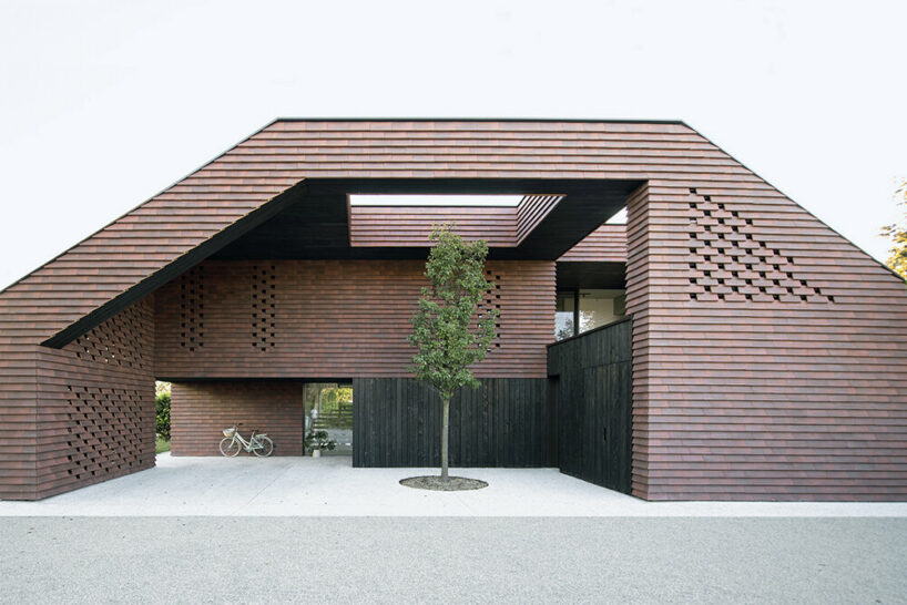 Brick canopy doubles as playground for OFIS Architects' frame house in Slovenia