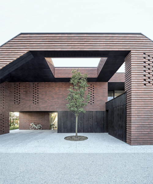 brick-tiled canopy doubles as playground for OFIS architects' frame house in slovenia